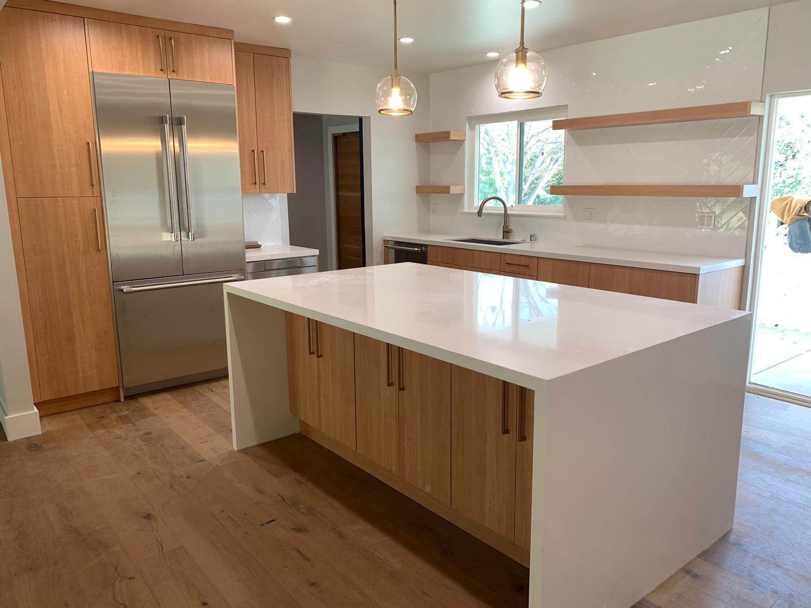 Completed kitchen remodel with white quartz island